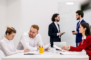 Obraz premium friendly business team create new business project or strategy of working in office, wearing formal clothes, intelligent people work together