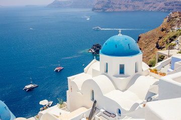 Fototapeta na wymiar Famous blue dome orthodox church in village of Oia on Santorini island in Greece in Europe. 
