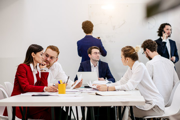 brainstorm of young successful business people gathered to discuss new business strategies, ideas together in modern office, successful interaction