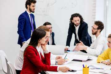 friendly business team in boardroom, in modern office gathered to discuss, have conversation about business strategies, ideas and projects. brainstorm of diverse young caucasian people in formal wear