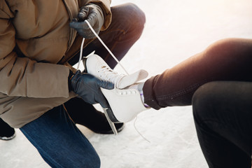 Ice skating lover couple having fun on snow winter holidays