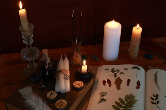 Magic Ritual Of The Alchemist With Candles, Runes And Symbols