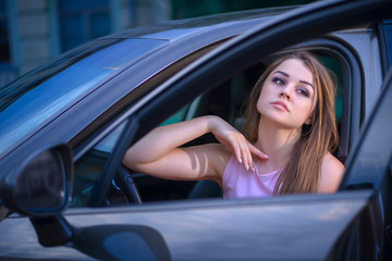 Fototapeta na wymiar glamorous girl driving a car
