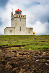Fototapeta na wymiar Iceland - Lighthouse Sitting Atop the Cliff