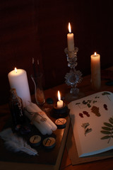 magic ritual of the alchemist with candles, runes and symbols