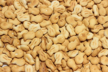 background texture of small crackers in the form of fish