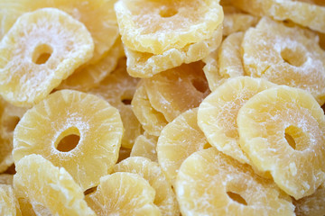 Slices of dried pineapple in sugar syrup. Dried pineapples top view.