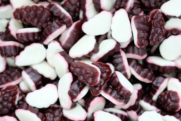Delicious jelly candies with grape juice. A lot of sweets with jelly and white souffle top view.