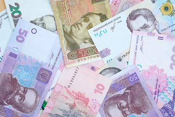 The national Ukrainian currency is in hryvnias. Ukrainian banknotes top view background. Currency of Ukraine of different denominations.