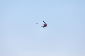 Small private helicopter on a background of blue sky
