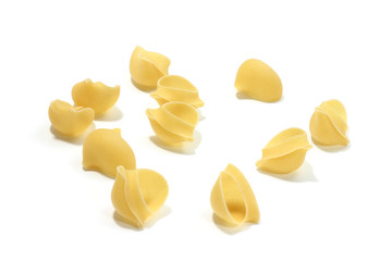 A lot of italian's raw pasta(macaroni) conchiglie on a white background