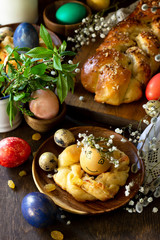 Easter pastries background. Colored eggs on a wooden table.