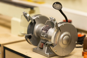The machine for sharpening. Work Desk in the workshop. The right tools to work with.