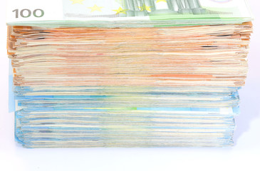pile of money in european banknotes on a white background