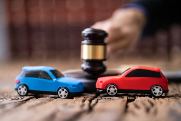 Two Cars On Desk In Courtroom
