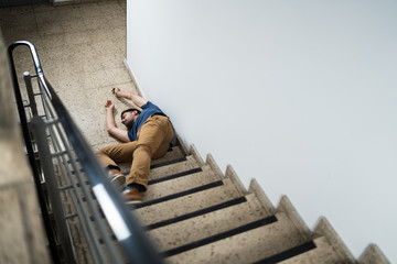 Unconscious Man Lying On Staircase