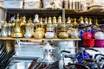 Arab gold traditional metal tea ware Dallah on the counter of the Eastern market.