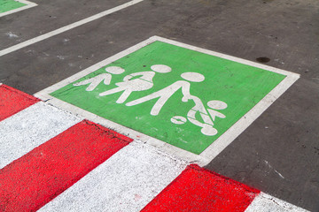 a sign on the ground - a parking space for families