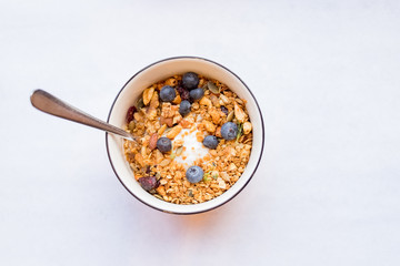bowl of muesli and yogurt with fresh berries. diet dessert with yogurt, granola and fresh berries, blueberries, care of health. proper diet.Healthy breakfast, yogurt with blueberries, muesli served in