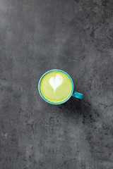 Matcha Latte with latte art on grey background top view