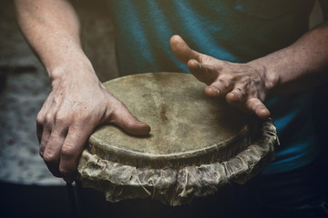 Fototapeta premium ethnic percussion musical instrument jembe and male hands
