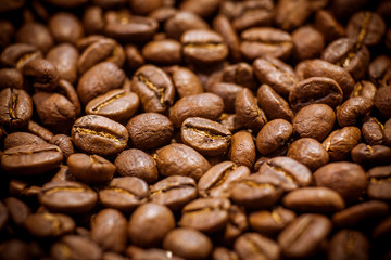Premium quality light roasted coffee beans rotating. Close up of brown roasted coffee beans