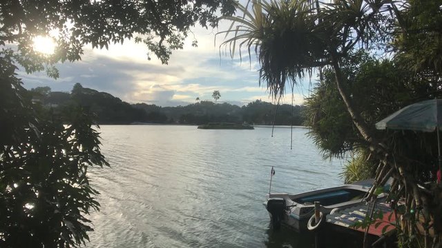 Kandy, Sri Lanka, the sun through the clouds on the lake 4K