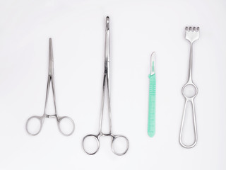 Flat lay of metal surgical instruments on white background. Tools for surgery