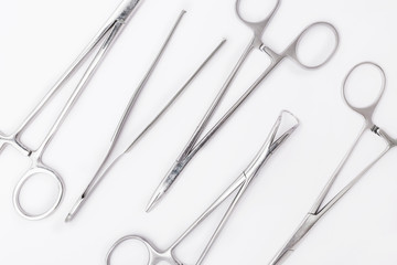 Plastic surgical tools background. Metal surgical instruments on white background