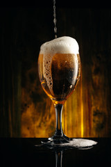 Glass of beer on wooden