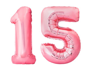 Number 15 fifteen made of rose gold inflatable balloons isolated on white background. Pink helium...