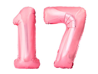 Number 17 seventeen made of rose gold inflatable balloons isolated on white background. Pink helium...