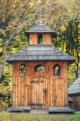 Old small wooden church in the park.