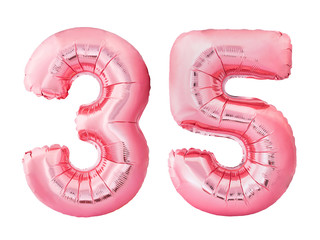 Number 35 thirty five made of rose gold inflatable balloons isolated on white background. Pink...