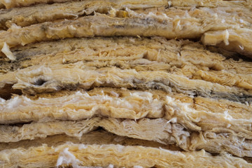 old insulation closeup, yellow glasswool closeup -
