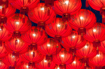 Chinese red lanterns hanging in street at night for decoration during the Chinese New Year festival at Chinatown, Ratchaburi, Thailand.Chinese Red lanterns illuminated at night
