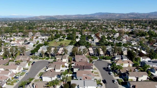 Aerial view of residential suburban packed homes neighborhood during blue sky day in Irvine, Orange County, USA