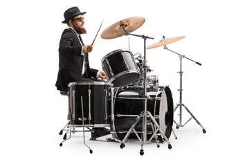 Male drummer in a suit playing with drumsticks