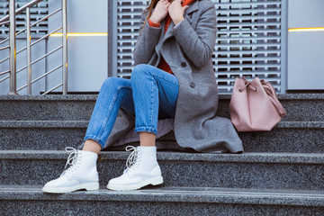 The girl with pink handbag in white boots