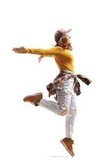 Young woman in casual clothes dancing and jumping