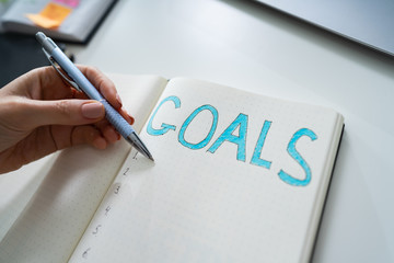 Businessperson's Hand Writing Goal Concept