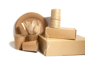 Crockery made from eco kraft paper, paper cups, dishes, bag, fast food containers isolated on white background. Recycling concept. Zero waste. Close-up..