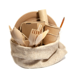 Crockery made from eco kraft paper, paper cups, dishes, bag, fast food containers isolated on white background. Recycling concept. Zero waste. Close-up..