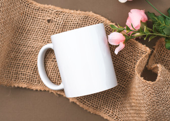 Rustic Elegance: Blank White Mug Mockup Set Against a Warm Brown and Burlap Backdrop
