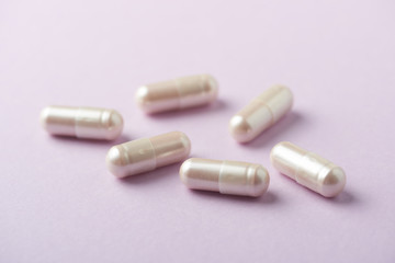 Carnitine capsules. Concept for a healthy dietary supplementation. Bright paper background. Soft focus. Close up.