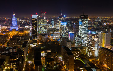 Aerial view of bright lights and nightlife in the business center of Warsaw-Poland. 03. December. 2019. Drone fired at a city at night with skyscrapers in the fog in the business district of Warsaw.