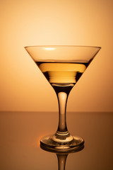 a glass of martini on a yellow background