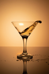 a glass of martini on a yellow background