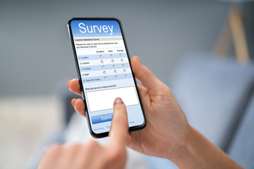 Person Filling Survey Form On Mobile Phone