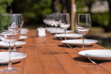 Served wooden table without a tablecloth. Cafe in the open air park